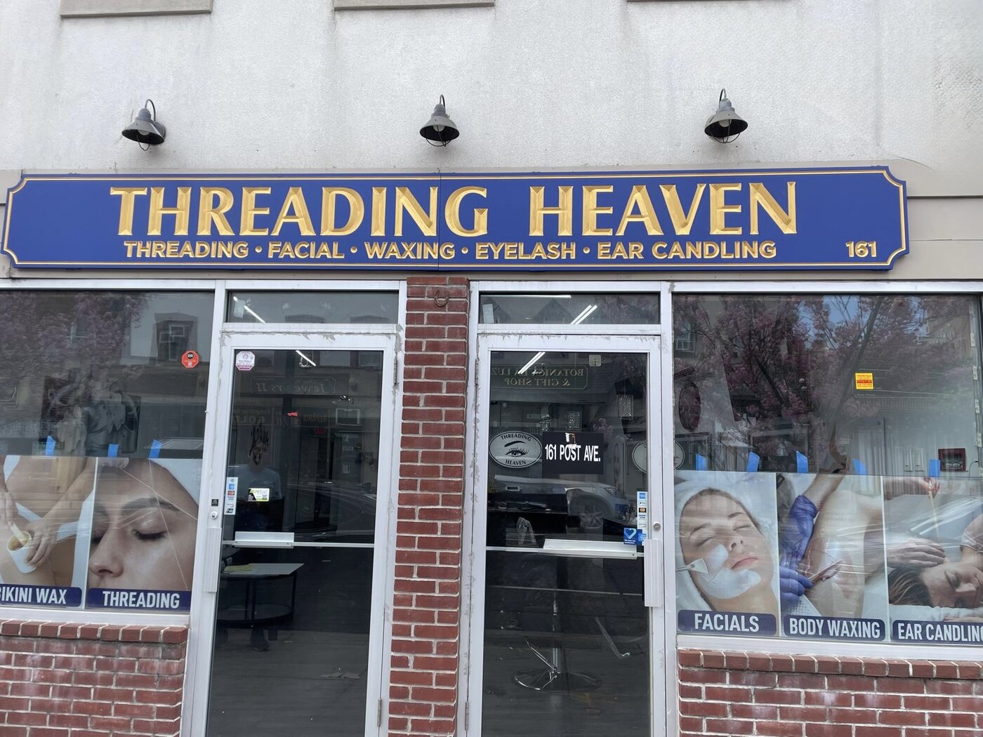 Threading Heaven storefront on 161 Post Ave, Westbury — blue and gold sign listing threading, facial, waxing, eyelash, and ear candling services