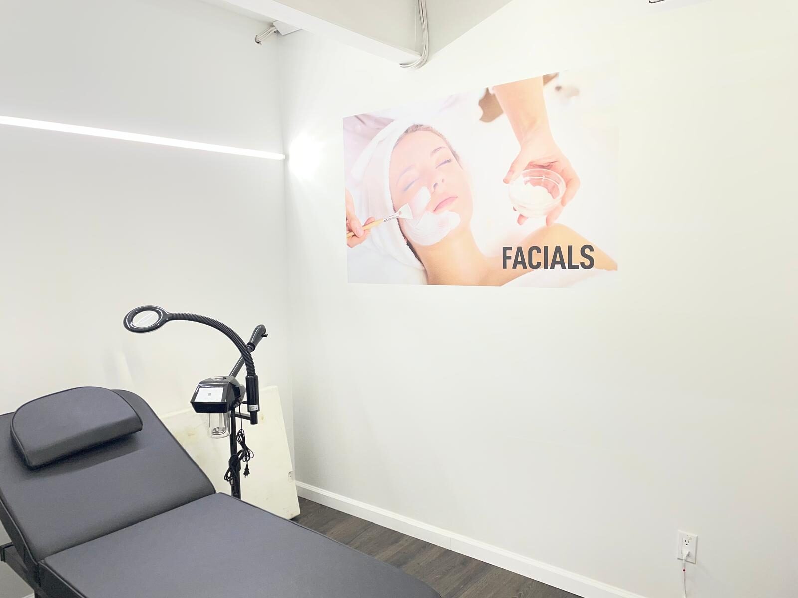 Threading Heaven's private facial treatment room with a single bed and magnifying lamp