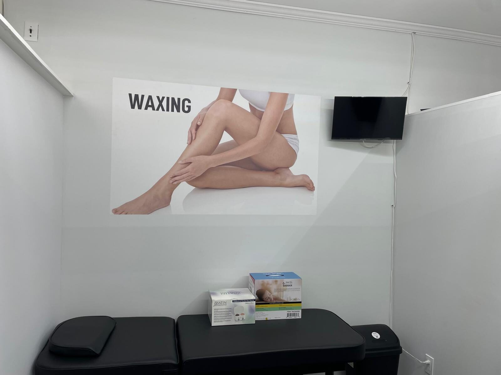 Threading Heaven's private waxing room with treatment bed and wax warmer